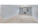 Large living room with neutral carpeting, light blue walls and modern chandelier at 710 S Clinton St # 6A, Denver, CO 80247