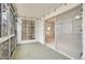 Sunroom with large sliding glass door and exterior lighting fixtures at 710 S Clinton St # 6A, Denver, CO 80247