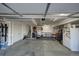 View of garage with stairs, workbench, storage and a refrigerator covered in stickers at 5536 Canyon View Dr, Castle Rock, CO 80104