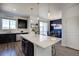 Well-lit kitchen featuring a spacious island with seating and dark cabinetry at 5536 Canyon View Dr, Castle Rock, CO 80104