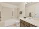 This bright bathroom features a vanity with a sink, a mirror, and a shower over the tub at 14001 E Marina Dr # 606, Aurora, CO 80014