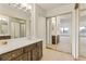 Bright bathroom with large mirrors and traditional wood vanity at 14001 E Marina Dr # 606, Aurora, CO 80014