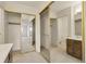 Well-lit bathroom featuring mirrored closet doors and a vanity at 14001 E Marina Dr # 606, Aurora, CO 80014