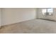 Spacious carpeted bedroom with a window offering natural light at 14001 E Marina Dr # 606, Aurora, CO 80014