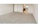 Neutral carpeted bedroom with a view to the attached bathroom and closet at 14001 E Marina Dr # 606, Aurora, CO 80014