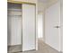 A closet in a bedroom offers storage space with a hanging rod and open sliding doors at 14001 E Marina Dr # 606, Aurora, CO 80014