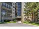 This exterior shot features the building's front facade on a sunny day with greenery at 14001 E Marina Dr # 606, Aurora, CO 80014