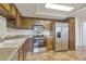 Well-equipped kitchen with stainless steel appliances, wooden cabinets, and laminate countertops, offering a practical cooking space at 14001 E Marina Dr # 606, Aurora, CO 80014