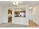 Partial view of a kitchen through an open wall showcasing wooden cabinets and stainless steel appliances, enhancing the open layout at 14001 E Marina Dr # 606, Aurora, CO 80014