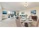 Inviting living room with a dining space showcases a marble table, comfortable seating, and artwork, creating an elegant atmosphere at 14001 E Marina Dr # 606, Aurora, CO 80014