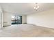 Spacious living room features a large window and balcony access, offering plenty of natural light and a comfortable living space at 14001 E Marina Dr # 606, Aurora, CO 80014
