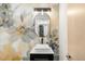 Powder room featuring decorative wallpaper, modern vessel sink, and stylish lighting at 333 S Monroe St # 211, Denver, CO 80209