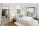 Bedroom featuring a window, white walls, and an ensuite bathroom at 333 S Monroe St # 211, Denver, CO 80209