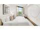 Bright bedroom with a large window, plush bedding, and neutral decor at 333 S Monroe St # 211, Denver, CO 80209