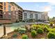 Beautiful exterior view of the building with lush landscaping, colorful flowers and greenery at 333 S Monroe St # 211, Denver, CO 80209