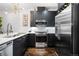 Well-lit kitchen boasts stainless steel appliances, dark cabinets, and a contemporary aesthetic at 333 S Monroe St # 211, Denver, CO 80209