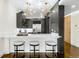 Modern kitchen with stainless steel appliances, white marble countertops, and stylish bar stool seating at 333 S Monroe St # 211, Denver, CO 80209