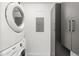 Laundry room with stacked washer/dryer and ample storage space at 333 S Monroe St # 211, Denver, CO 80209