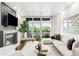 Bright living room with fireplace, large windows, and a comfortable seating area at 333 S Monroe St # 211, Denver, CO 80209