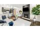 Open concept living room featuring a modern fireplace, hardwood floors, and stylish decor at 333 S Monroe St # 211, Denver, CO 80209