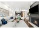 Open-concept living room features a modern kitchen, fireplace, and stylish decor at 333 S Monroe St # 211, Denver, CO 80209