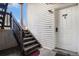 Property entrance featuring staircase with white door, unit number, and secure key system at 17505 E Mansfield Ave # 1411L, Aurora, CO 80013