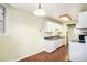Bright kitchen featuring white cabinets, laminate countertops, and modern appliances at 17505 E Mansfield Ave # 1411L, Aurora, CO 80013