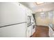 Kitchen features a white refrigerator and range and wood-look flooring at 17505 E Mansfield Ave # 1411L, Aurora, CO 80013