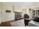 Comfortable living room with a stone fireplace as a focal point and gleaming wood floors at 17505 E Mansfield Ave # 1411L, Aurora, CO 80013