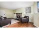 A inviting living room is accented by wood floors and a stone fireplace, blending comfort and style at 17505 E Mansfield Ave # 1411L, Aurora, CO 80013