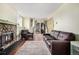 Cozy living room with hardwood floors, fireplace, and sliding glass doors at 17505 E Mansfield Ave # 1411L, Aurora, CO 80013