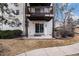 Exterior view of a patio with a sliding glass door and covered balcony above at 17505 E Mansfield Ave # 1411L, Aurora, CO 80013