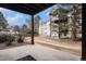 A shaded patio with a view of the building's exterior and surrounding trees at 17505 E Mansfield Ave # 1411L, Aurora, CO 80013