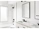 Modern bathroom with double vanity, marble tile, and soaking tub at 3044 W 29Th Ave, Denver, CO 80211