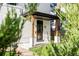 Inviting front porch with modern wood posts and black door at 3044 W 29Th Ave, Denver, CO 80211