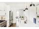 Modern kitchen with white cabinets and a marble island at 3044 W 29Th Ave, Denver, CO 80211