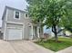 Charming two-story home with attached garage, well-maintained lawn, and mature trees in a serene neighborhood at 1286 Finch Ave, Brighton, CO 80601