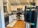 Well-lit kitchen with stainless steel appliances, dark countertops, and white cabinets, perfect for modern cooking at 1286 Finch Ave, Brighton, CO 80601