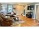 Bright living room with wood floors, comfortable seating, and a TV setup, creating a cozy entertainment space at 1286 Finch Ave, Brighton, CO 80601