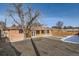 Rear exterior view of home with brick siding, wood accent wall and spacious yard at 1330 E 90Th Ave, Thornton, CO 80229