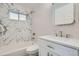 Stylish bathroom features modern vanity, marble wall tiles, and shower-over-tub combination at 1330 E 90Th Ave, Thornton, CO 80229