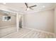 Neutral bedroom with wood-look floors, a ceiling fan, and mirrored closet doors at 1330 E 90Th Ave, Thornton, CO 80229