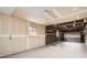 Spacious unfinished garage with concrete floor, shelving, and a roll-up door at 1330 E 90Th Ave, Thornton, CO 80229