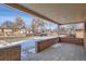 A covered front porch with a tiled floor and brick surrounding wall at 1330 E 90Th Ave, Thornton, CO 80229