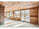 Bright sunroom with wood ceiling and walls, featuring tile flooring and multiple windows at 1330 E 90Th Ave, Thornton, CO 80229