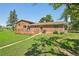 Expansive backyard with lush lawn, mature trees, and a charming back deck. Perfect for outdoor activities at 8840 Niwot Rd, Niwot, CO 80503