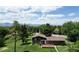 Backyard shot showcasing a house with a deck overlooking a lush green lawn, perfect for outdoor living at 8840 Niwot Rd, Niwot, CO 80503