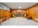 Finished basement featuring wood paneled walls and a brick fireplace at 8840 Niwot Rd, Niwot, CO 80503