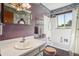 Well-lit bathroom with a single sink vanity and combined shower and tub at 8840 Niwot Rd, Niwot, CO 80503