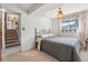 Cozy bedroom features a window with curtains and staircase access at 8840 Niwot Rd, Niwot, CO 80503